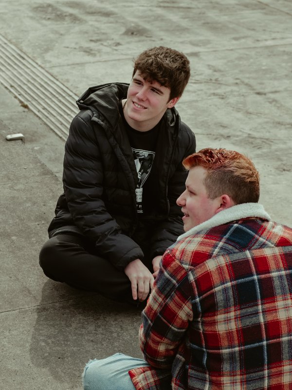 Dyfodol Ni - S3 members on steps outside in Cardigan discussing plans for the project